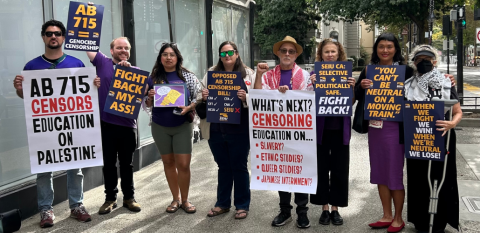 Eight people hold printed signs, many in the yellow/purple SEIU style: 
