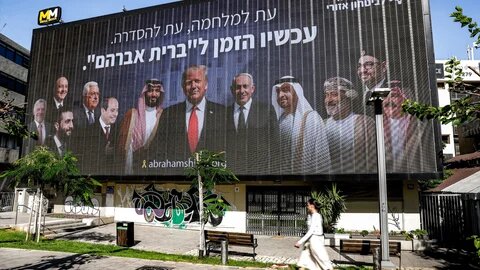 A billboard in Tel Aviv, put up by an Israeli campaign group, depicts Arab leaders alongside Benjamin Netanyahu and Donald Trump under the slogan 'Now is the time for the Abraham Covenant', 26 June 2025 (Jack Guez/AFP)