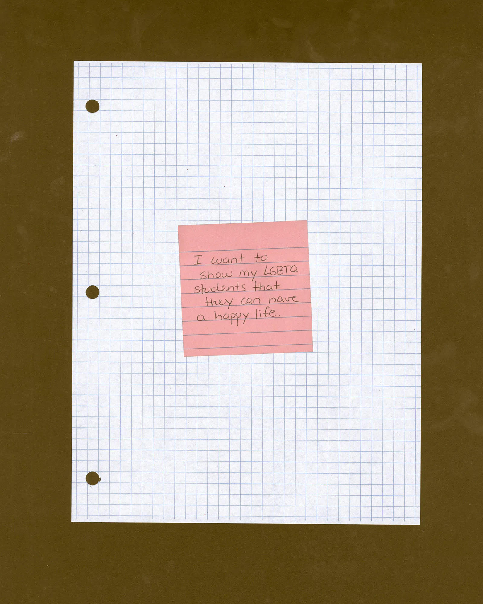 Grid paper with a pick Post-It Note with "I want to show my LGBTQ students that they can have a happy life" written on it.