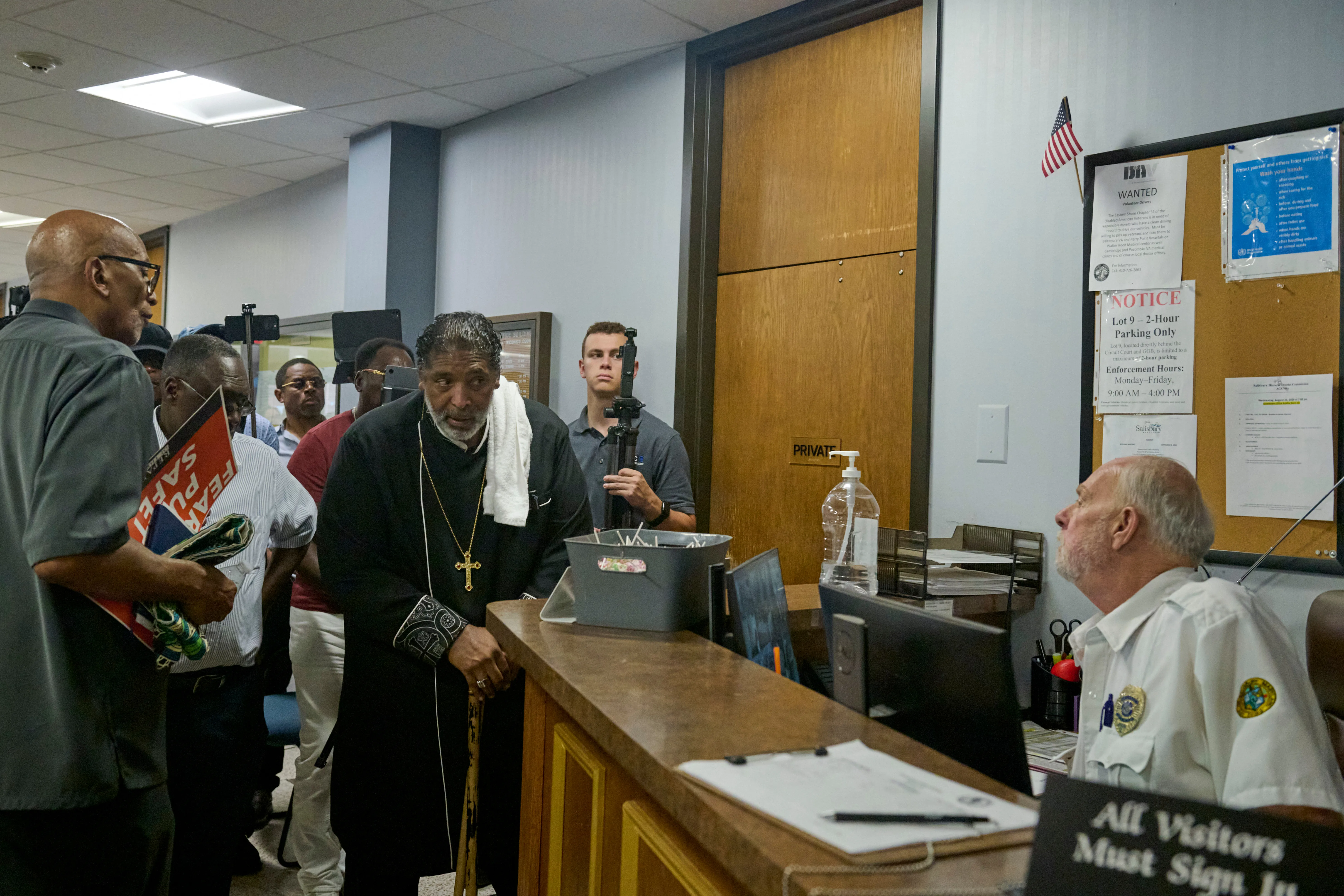 Rev. William Barber and other protestors argue with security officials in Wicomico County Government building.